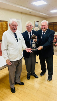 Moderator Bill Duncan presenting the trophy to the Edinburgh HC Bowling Section President and Secretary